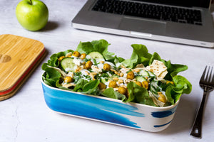 
                  
                    salad in blue wave bamboo lunch box  in front of computer
                  
                