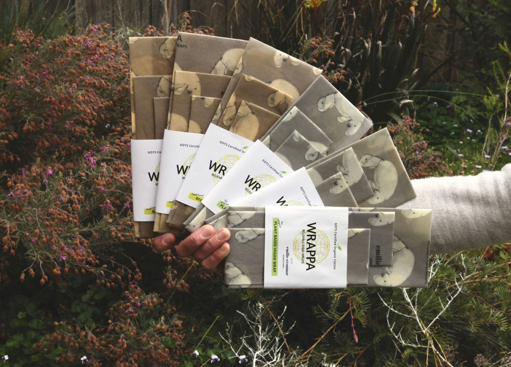 three packs of dugong printed beeswax wraps and vegan wax food wraps in a fan shape